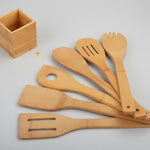 Set of bamboo kitchen utensils including spatulas and a ladle on a white background.